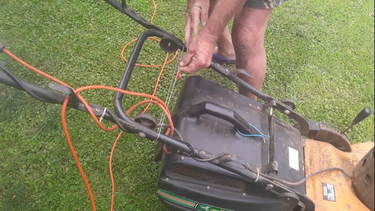 ViceTye securing a power cord on a lawnmower